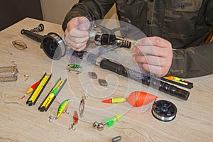 Fisherman prepare to fishing. Tools and accessories on wooden table