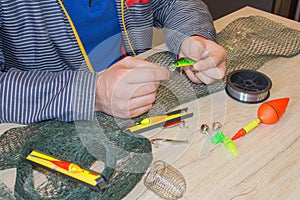 Fisherman prepare to fishing. Tools and accessories on wooden table