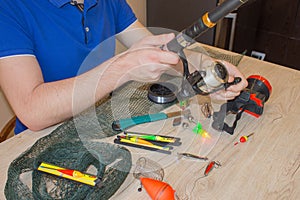 Fisherman prepare to fishing. Tools and accessories on wooden table