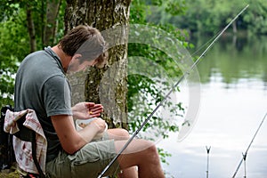 Fisherman preparing lure, fishing getaway hobby concept