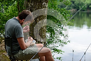 Fisherman preparing lure, fishing getaway vacation photo