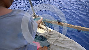 Fisherman Pulling Fishing Net in Sea by Traditional Method