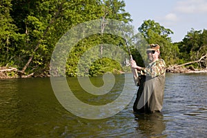 Fisherman pulls caught salmon