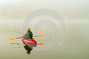 Fisherman in red kayak