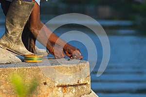 Fisherman is reeling in his line with determination and focus