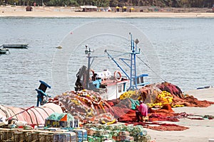 Fisherman, repairing his nets, in port of Sines, Portugal photo