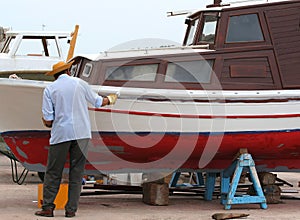 Fisherman repairs the boat