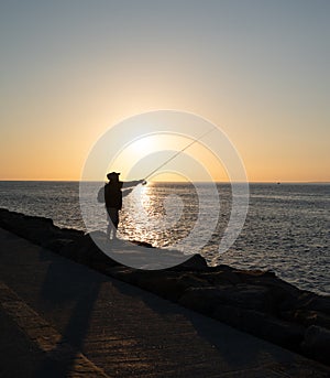 Fisherman\'s backlight lowers the sunset