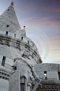 Fisherman's Bastion (Halaszbastya) fortification under pink sunset sky with Knight sculptures in Budapest, Hungary.