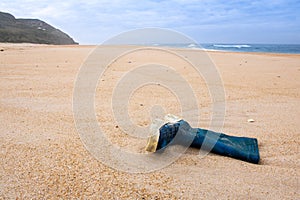 Fisherman`s boot left on the sand at empty beach