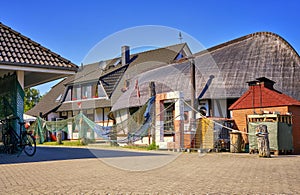 Fisherman's house with bicycle and fishing net at the harbor. Weisse Wiek in Boltenhagen on the Baltic Sea. Germany