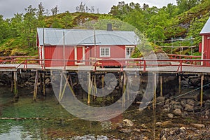 Fisherman`s house at the edge of the waterfront in the harbor of Nusfjord