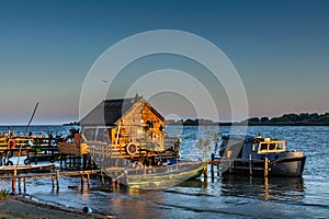 Fisherman's House, the old dock and the boat on the lake. Rustic