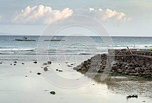 Fisherman\'s huts,in the distance,floating out at sea at low tide,on bamboo platforms,Oslob,Cebu Island,The Philippines