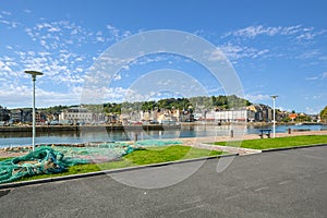 A fisherman`s net lies on a small stretch of park across the port from the fishing village of Honfleur France in the Normandy Regi