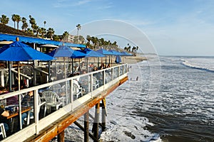 Fisherman`s restaurant on San Clemente Pier with beach and coastline on background. photo