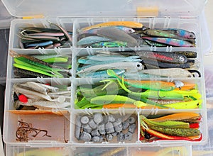 A fisherman's tackle box with lures and gear for fishing