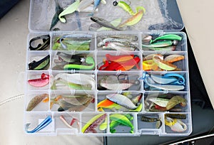 A fisherman's tackle box with lures and gear for fishing