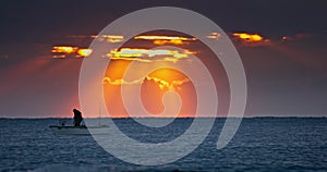 Fisherman Sailing on Fishing Boat Silhouette Setting Net With Sunrise Water Reflection, nature video