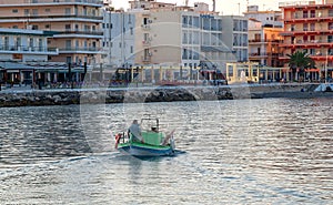 A fisherman is sailing in his boat for fish in Loutraki