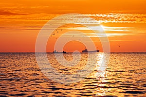 Fisherman sailling with his boat on beautiful sunrise over the sea