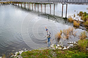 Fisherman with salmon on the hook, Brooks River, Katmai National Park, Alaska