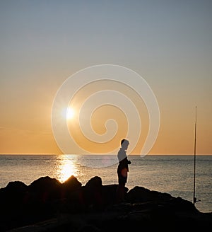 fisherman shadow on the rocks of Punta Ballena coastline on the bay of Solanas, atlantic ocean, Maldonado, Uruguay