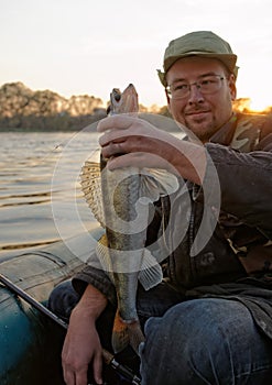 Fisherman is showing a walleye