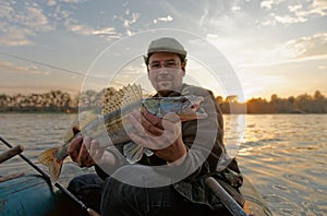 Fisherman is showing a walleye