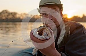 Fisherman is showing walleye's teeth