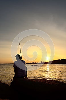 Fisherman silhouette on the beach