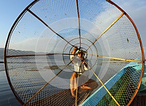 Fisherman silhouette with net at Inle lake