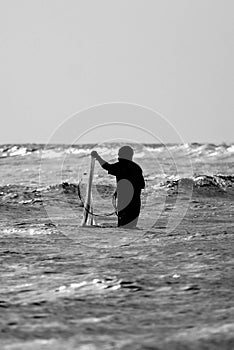 Fisherman silhouette with a net at the sea