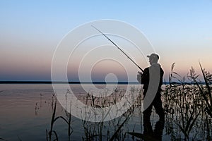 Fisherman silhouette at sunset