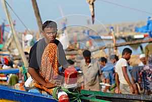 Fisherman sits at the front side of the fishing boat just arrived to the port in Al Hudaydah, Yemen.