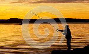 A fisherman in sunset.