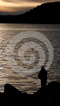 A fisherman at sunset at Lake Tahoe, Nevada.