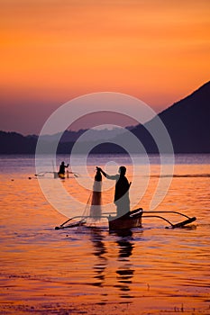 Fisherman at Sunset in Taal Lake, Philippines photo