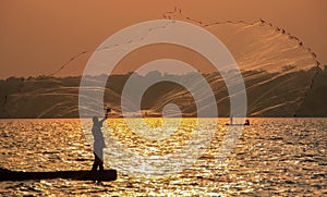 Fisherman throws a net in Lake Victoria. Uganda