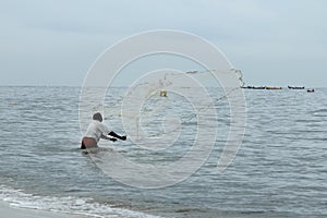 Fisherman throws out his net