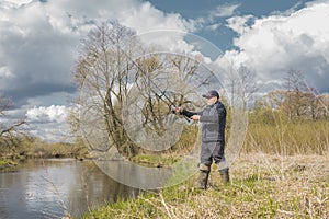 Fisherman throws a spinning rod