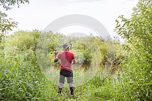 Fisherman throws a spinning view from the back