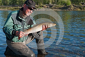 Fisherman with trout fish