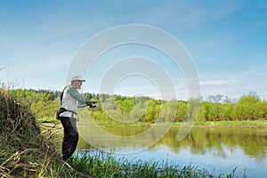 Fisherman trying to do a perfect cast, throwing lure. Spining fishing, angling, catching fish