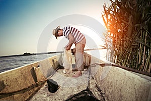Fisherman untangling the net