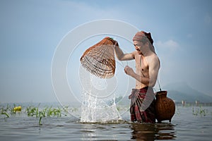 Fisherman using traditional fishing gear to catch fish for cooking,