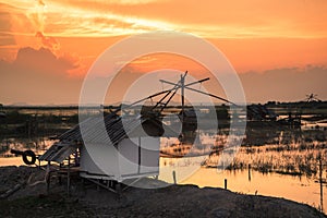 Fisherman village with giant fish net at sunset