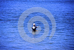 Fisherman in Waders Casts   15388