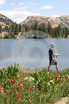 Fisherman walking by lakeside