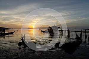 Fisherman wooden hut and sink boat near sea coastal